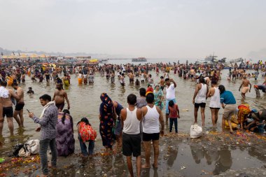 spiritual gathering of devotees at triveni sangam at mahakumbh festival at day image is taken at mahakumbh mela prayagraj uttar pradesh india on Feb 17 2025. clipart