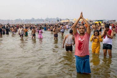 sacred devotees offering holy pryer at triveni sangam at mahakumbh festival at day image is taken at mahakumbh mela prayagraj uttar pradesh india on Feb 17 2025. clipart