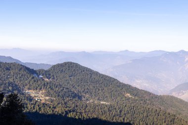 Sabah görüntülerinde yeşil ormanlarla kaplı dağ sıraları ve beyaz sis Chandrashila trek tungnath chopta uttarakhand Hindistan 'da çekilir..