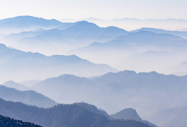 breathtaking mist covered mountain range at morning image is taken at chandrashila trek tungnath chopta uttarakhand india.
