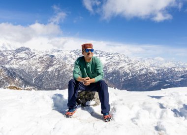 Geleneksel şapkalı yalnız yürüyüşçü zirveden parlak mavi gökyüzü görüntüsüne hayran kaldı Chopta Tungnath Himalayas dağında Chandrashila trek uttarakhand Hindistan 'da..