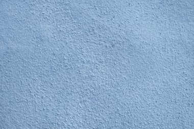 Küçük çıkıntıları ve pürüzlü alçı yüzeyi olan mavi sıva dokusu. Detaylı kusurlu, tasarım, mimari veya yaratıcı projeler için ideal, ılık tonlu arka plan