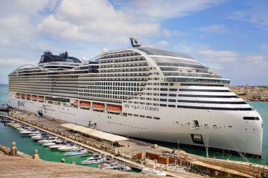 Valletta, Malta - 04.23.2025: Çok katlı yolcu gemisi MSC World Europa yolculara kalkıştan önce binecek. Lüks bir gemi rıhtıma yanaştı, deniz yolculuğu için hazır..