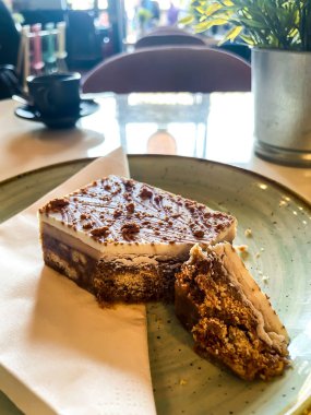 Geleneksel İskoç tatlısı, beyaz çikolatayla kaplı kurabiye. Kafede dekoratif bir bitkiyle birlikte bir tabakta servis edilmiş..