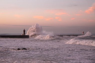 Douro river mouth at orange dawn during storm