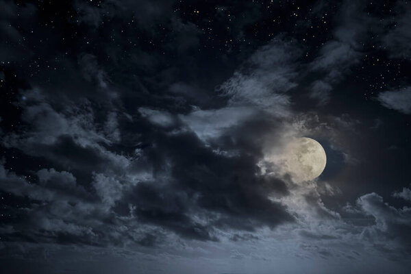 Cloudy full moon night sky with stars