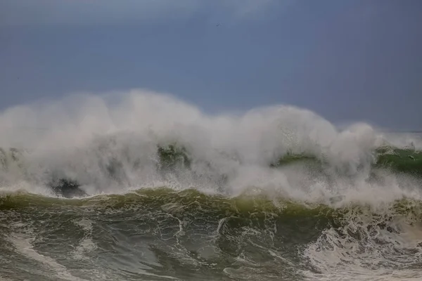 Huge breaking stormy wave. Northern portuguese coast.