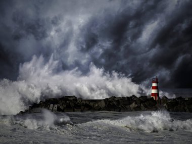 Storm waves over beacon of the harbor of Povoa do Varzim, Portugal - enhanced sky clipart