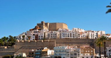 view of Pescola, a coastal city in Spain, located in the region of Valencia. The city is known for its castle, built on a rocky peninsula that juts out into the sea