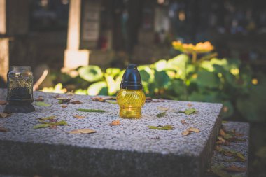 Tüm ruhlar gününde fener, mum, kasımpatı çiçeği, hüzünlü ve huzurlu bir atmosfer ile süslenmiş mezar.