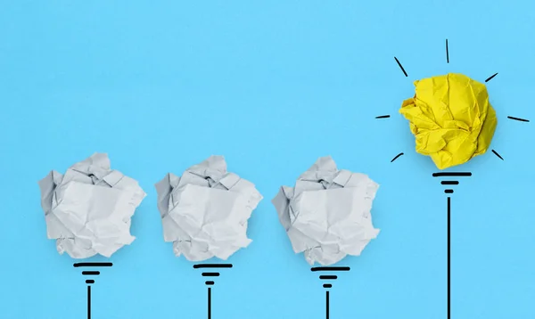 Creative idea, Inspiration, New idea and Innovation concept with Crumpled Paper light bulb on blue background