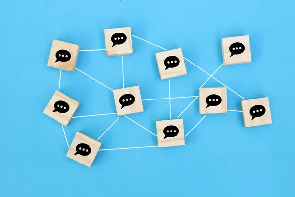 Concept of online communication or social networking. cubes with speech bubbles linked to each other with lines.
