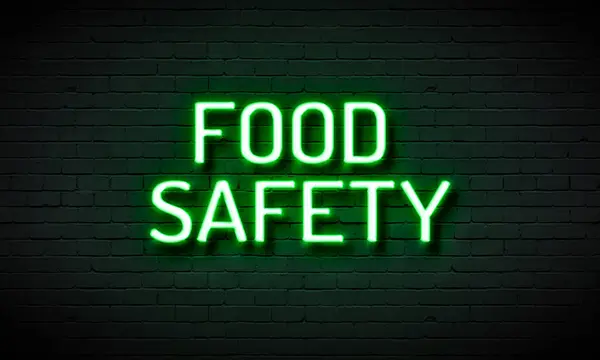 glowing neon food sign on brick wall background