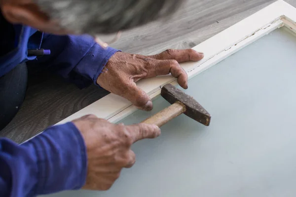 stock image worker using a hammer in woodwork constructio