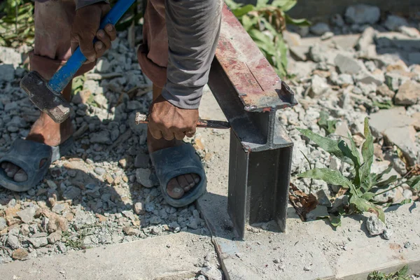Construction technicians use hammer chisels to destroy steel