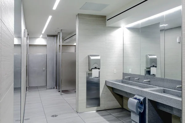 urinals in public restroom for men