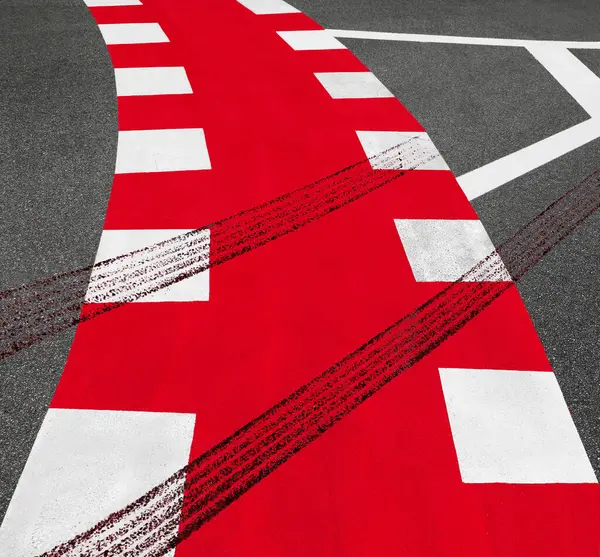 imprint of a car braking on a red pedestrian crossing