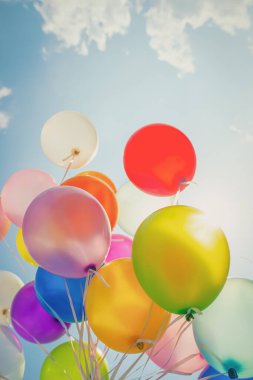 multi colored balloons done with a retro vintage  filter effect. concept of festival, celebration, birthday, for background design.