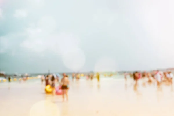 Abstract seascape blurred beach background. blur people on beach sea and sky. summertime vacation background concept. retro color effect