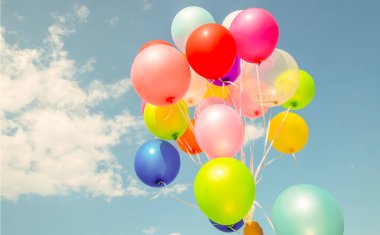 multi colored balloons done with a retro vintage  filter effect. concept of festival, celebration, birthday, for background design.