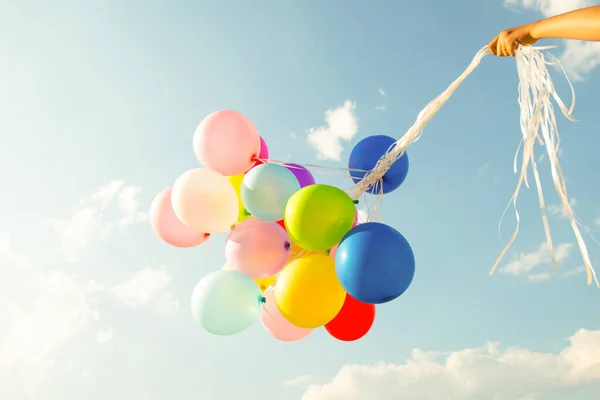 Hand Holding Multi Colored Balloons Done Retro Vintage Filter Effect — Fotografia de Stock