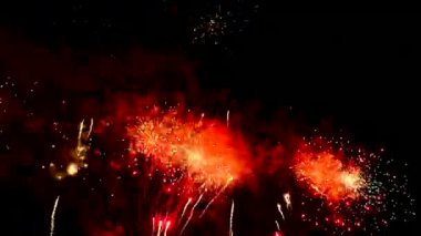 4 bin. Gerçek havai fişeklerin kusursuz döngü arka planında gece gökyüzünde Bokeh ışıkları olan altın havai fişekler. Parlak havai fişek gösterisi. Yeni yıl arifesinde havai fişekler Bangkok 'ta çeşitli renkleri kutluyor