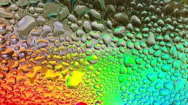 Metal yüzeydeki su damlacıklarının yoğunlaşmasını gösteren yüksek çözünürlüklü su damlalarının yakın çekim görüntüsü. Karmaşık desenler ve farklı boyutlarda su damlacıkları güzel bir soyut oluşturur.