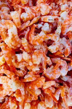 Kurutulmuş karidese yakın çekim. Küçük, pembemsi-turuncu renkte, pişerken şeffaf görünür. Kurutulmuş karides genellikle çeşitli Asya yemeklerinde baharat ya da malzeme olarak kullanılır.