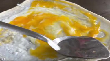 4k Street yiyecek satıcısı hamur ve tavada kızartılmış paratha roti 'yi dışarıda çıtır çıtır olana kadar kızgın yağda hazırlıyor. Sokak işportacısı sabah kahvaltısı için prata ekmeği veya roti canai hazırlıyor.