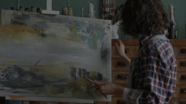Artist Creating Her Masterpiece. Female painter in workshop. Woman working in art space. 4K