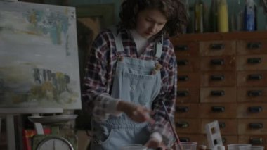 Artist Preparing Colors For Painting. Female painter creating artworks in workshop. 4K