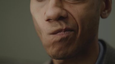 Kasvetli Siyah Adam Ağzı. Afro-Amerikan erkek ağzı kameraya negatif duygu gösteriyor. Tatmin olmamış yüz ifadesi. 4K