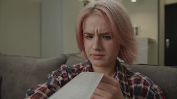 Young Adult Woman Shocked High Expenses Holding Receipt — Stock Video