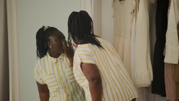 镜像反射中检查皱纹的黑人妇女 站在衣柜里的非洲女人笑着 — 图库视频影像