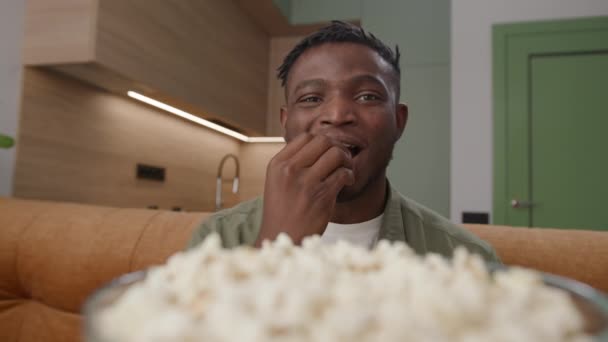 Czarny Człowiek Jedzący Popcorn Patrzący Kamerę Dwudziestce Afroamerykanin Przekąski Zamknij — Wideo stockowe