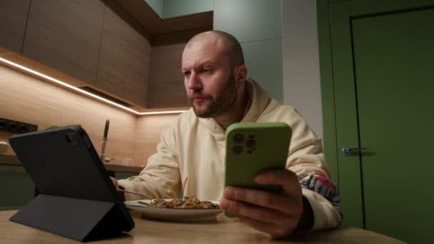 Der Jährige Mann Genießt Pasta Und Wechselt Nahtlos Zwischen Handy — Stockvideo