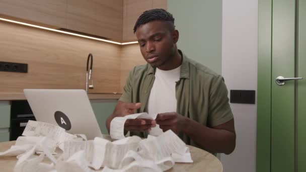 African American Man Sifts Receipts Stunned High Expenses While Managing — Stock Video