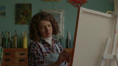 Painter Creating Artwork Close Up. Female artist painting on canvas in workshop. 4K