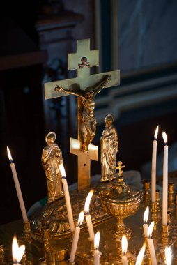 ISTANBUL, TURKEY, JANUARY 17, 2018: Jesus on the cross and candles inside Bulgarian St. Stephen Church, an orthodox church in Balat, famous for being made of prefabricated cast iron elements.