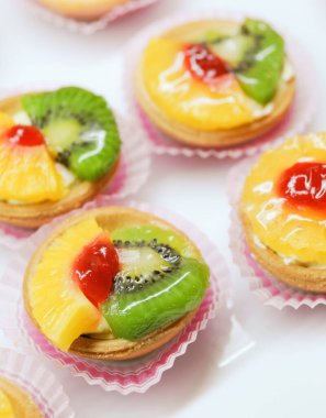 Mini Tarts Decorated With Pineapple and Kiwi Slices
