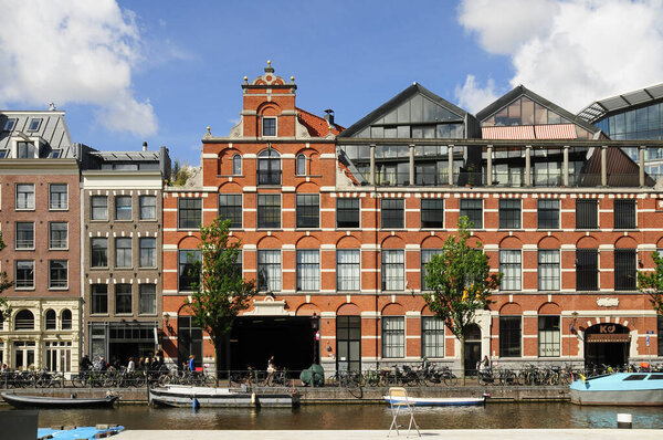 AMSTERDAM, NETHERLANDS, JULY 12, 2012: Old but renovated apartments from Amsterdam, capital of the Netherlands, has more than one hundred kilometres of canals, about 90 islands and 1,500 bridges.