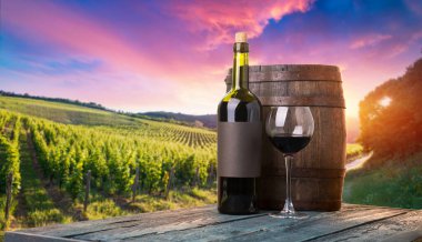 Barrel Wineglasses Cheese And Bottle In Vineyard At Sunset . High quality photo