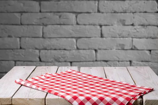 top view with red empty kitchen napkin isolated on table background. Folded cloth for mockup with copy space, Flat lay. Minimal style. High quality photo