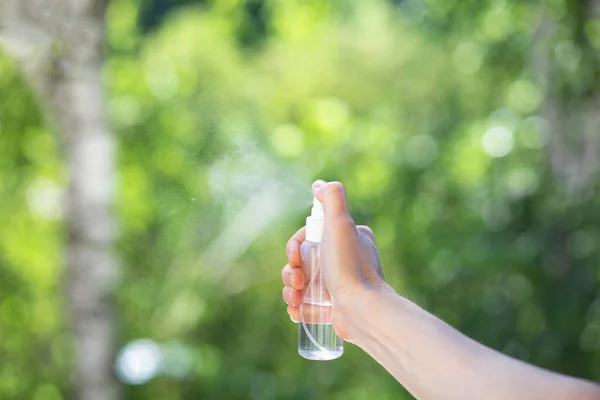 stock image Splashes with a spray on a blurred green background of trees.