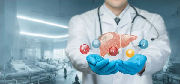 Doctor supports the liver with vitamins on a blurred background.