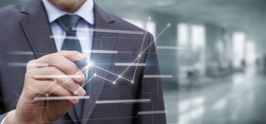 A businessman works on a virtual computer with a business plan and financial development.