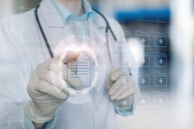 Doctor works with electronic patient record on virtual computer screen.