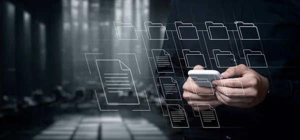 stock image Businessman working with folders in archives on mobile device and virtual screen.