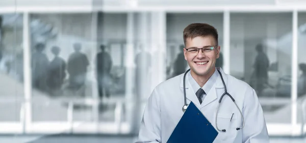 Stock image A young medical worker in glasses on a blurred background.