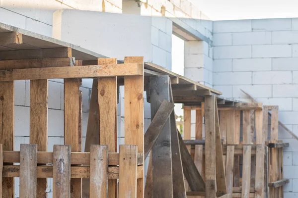 stock image Wooden scaffolding for construction is assembled by hand at the construction site.